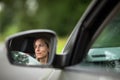 Pretty midle aged woman at the steering wheel of her car