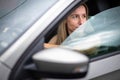 Pretty midle aged woman at the steering wheel of her car