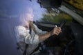 Pretty midle aged woman at the steering wheel of her car