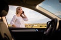 Pretty midle aged woman  having a break on a long trip, making a phone call Royalty Free Stock Photo