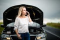 Pretty midle aged woman at the steering wheel of her car