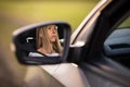 Pretty midle aged woman at the steering wheel of her car