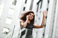 Pretty mixed race businesswoman speak by phone in city. Royalty Free Stock Photo