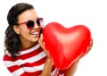 Pretty mixed race girl holding red heart balloon Royalty Free Stock Photo