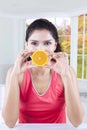 Pretty model holds orange piece