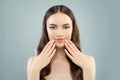 Pretty model woman smiling on light blue background. Clear skin, perfect manicure