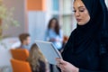 Pretty modern Arabian woman with tablet computer