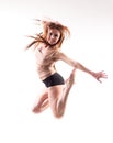 pretty modern slim hip-hop style teenage girl jumping dancing isolated on a white studio background Royalty Free Stock Photo