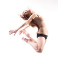 pretty modern slim hip-hop style teenage girl jumping dancing isolated on a white studio background Royalty Free Stock Photo