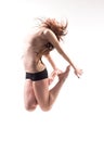 pretty modern slim hip-hop style teenage girl jumping dancing isolated on a white studio background Royalty Free Stock Photo