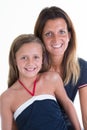 mother with beauty child daughter posing on white wall