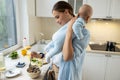Happy woman standing with her kid in the kitchen at home Royalty Free Stock Photo