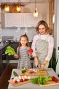 pretty mother and kid girl preparing healthy food for family, vegan salad Royalty Free Stock Photo