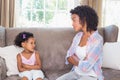 Pretty mother sitting on couch with petulant daughter Royalty Free Stock Photo