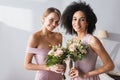 pretty multiethnic bridesmaids holding wedding bouquets Royalty Free Stock Photo