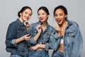 Pretty multiethnic women in denim jackets