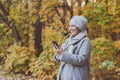 Pretty muslim woman using mobile phone outdoor. Arabic female wearing hijab using smartphone. Islamic girl texting a