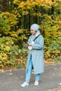 Pretty muslim woman using mobile phone outdoor. Arabic female wearing hijab using smartphone. Islamic girl texting a