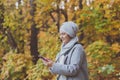 Pretty muslim woman using mobile phone outdoor. Arabic female wearing hijab using smartphone. Islamic girl texting a