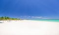 Pretty natural white sand tropical palm beach and tranquil turquoise ocean view