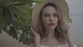 Pretty naturally looking woman on summer day with straw hat