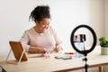 Pretty overweight lady makeup artist recording video while doing manicure Royalty Free Stock Photo