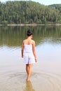 Pretty girl walking into water Royalty Free Stock Photo