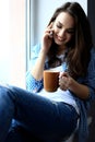 Pretty peaceful young woman using cell phone and Royalty Free Stock Photo