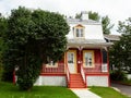 Pretty petite ancestral neoclassical red house with metal sheet roof