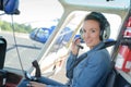 Pretty pilot woman in helicopter ready to takeoff Royalty Free Stock Photo