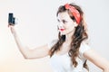 Pretty pin up girl vintage camera taking picture Royalty Free Stock Photo