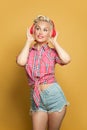 Pretty pin-up woman listening music with headphones and posing Royalty Free Stock Photo