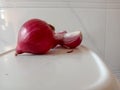 Pretty Pink colored peeled and fresh spicy onion cut three part cut