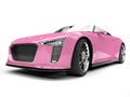 Pretty pink modern cabriolet sports car - low angle front view