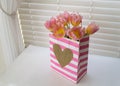 Pink tulips in a striped Valentine bag Royalty Free Stock Photo