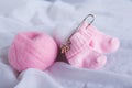 Pretty pink woolen baby socks on white background