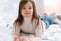 Pretty pleasant girl lying on the bed