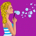 Pretty pop art girl blowes soap bubbles