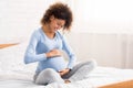 Pretty pregnant woman caressing her belly, talking to her baby Royalty Free Stock Photo