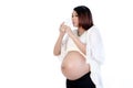 Pretty pregnant woman drinking glass of milk