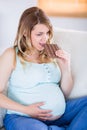 Pretty pregnant woman eating big bar of chocolate Royalty Free Stock Photo