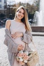 Happy and carefree pregnant woman stand near the fountain Royalty Free Stock Photo