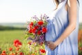 Pregnant woman outdoors at poppy field Royalty Free Stock Photo