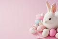 Pretty rabbit surrounded by easter eggs on a pink background, text space Royalty Free Stock Photo