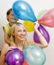 Pretty real family with color balloons on white background, blond woman with little boy at birthday party bright smiling Royalty Free Stock Photo