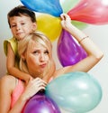 pretty real family with color balloons on white background, blond woman with little boy at birthday party bright smiling Royalty Free Stock Photo