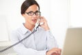 Pretty receptionist using the phone at workplace Royalty Free Stock Photo