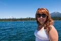 Pretty red hair female adult poses by Lava Lake along the Cascade Lakes Scenic Byway