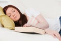 Pretty red-haired girl having rest while studying Royalty Free Stock Photo