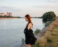 pretty red-haired woman in black dress outdoors posing fresh air Royalty Free Stock Photo